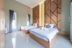 a bedroom with two beds and a large window at Modern 3BDR Villa - Between Seminyak & Canggu in Kerobokan +11 photos
