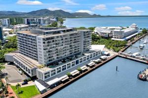 an aerial view of a large building next to the water at Panoramic Views at Harbour Light on the Waterfront in Cairns