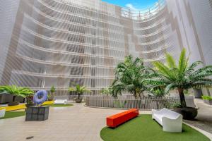a rendering of a large building with palm trees at Panoramic Views at Harbour Light on the Waterfront in Cairns