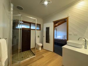 a bathroom with a shower and a toilet and a sink at BIG4 Tasman Holiday Parks - Bright in Bright +106 photos