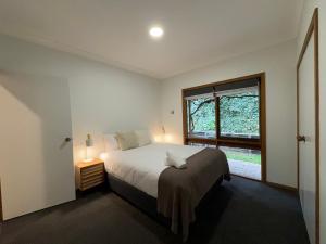 a bedroom with a large bed and a window at BIG4 Tasman Holiday Parks - Bright in Bright