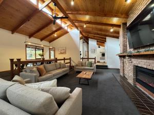 a living room with couches and a fireplace at BIG4 Tasman Holiday Parks - Bright in Bright