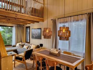 a living room with a table and a couch at Ailen de los Andes Deluxe in San Martín de los Andes