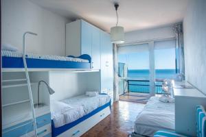 Кровать или кровати в номере Sole Surf E Relax - Happy Rentals