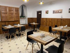 a dining room with wooden tables and chairs at Valencia Hotel in Odesa