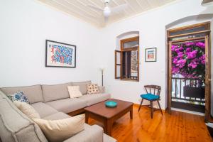 a living room with a couch and a table at The Bougainvillea in Skopelos Town