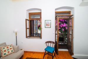 a living room with a couch and a chair at The Bougainvillea in Skopelos Town