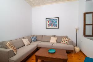 a living room with a couch and a table at The Bougainvillea in Skopelos Town