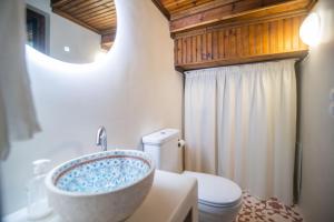 a bathroom with a sink and a toilet at The Bougainvillea in Skopelos Town +31 photos