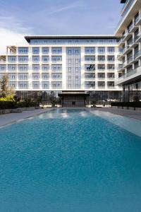 a large swimming pool in front of a building at Sea Breeze Lighthouse 3 in Baku