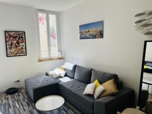 a living room with a couch and a table at 7 Rue des Poilus in La Ciotat