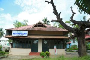 a building with a sign that reads rise restaurant at Hotel Nandanam in Guruvāyūr