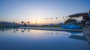 a swimming pool with a sunset in the background at Villa Pirello in Guardiagrele