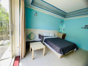 Postel nebo postele na pokoji v ubytování 大潭山莊 Da Tan Mountain INN
