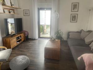 a living room with a couch and a coffee table at Ferienhaus Mathilda in Kusel
