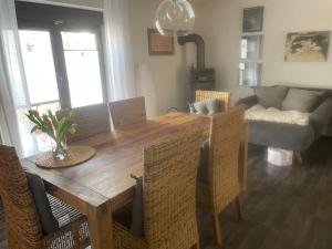 a dining room table with chairs and a couch at Ferienhaus Mathilda in Kusel +9 photos