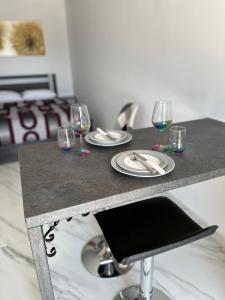 a table with three glasses of wine on it at Maria’s studio in Paphos City