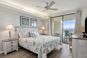 a bedroom with a bed and a view of the ocean at Summer House Condos in Orange Beach