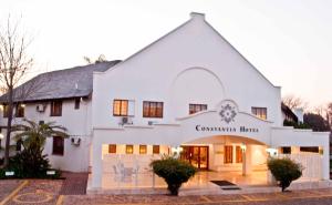a white building with a sign that reads coventry house at Constantia Hotel and Conference Centre in Midrand