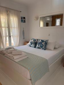 a bedroom with a large bed with a mirror at Simos suites in Elafonisos