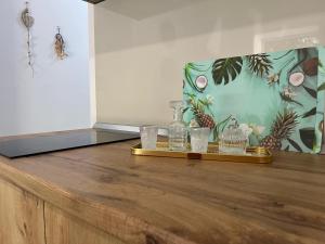 a tray with glasses and bottles on a wooden table at Doris Apartments in Himare +29 photos