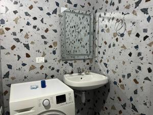 a bathroom with a sink and a washing machine at Doris Apartments in Himare