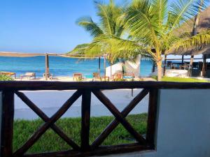 a view of the beach from a fence at AVO Boutique Hotel in Dikoni