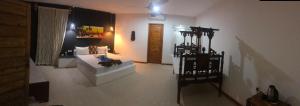 a room with a bedroom with a bed and a table at AVO Boutique Hotel in Dikoni