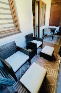 a patio with tables and chairs on a building at Casa Alpina Top 33 in Saalbach Hinterglemm