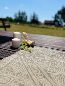 para świec stojących na drewnianym stole w obiekcie Przystanek Gałkowo w mieście Gałkowo