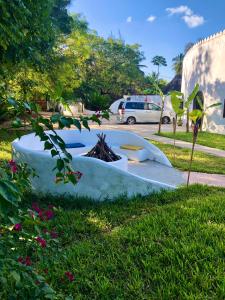 a boat sitting on the grass in a yard at AVO Boutique Hotel in Dikoni