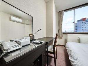 Postel nebo postele na pokoji v ubytování Okasan Hotel