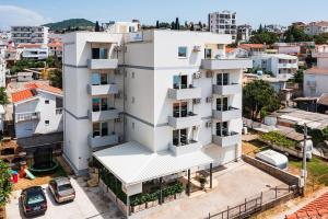 an aerial view of a white building in a city at Apartmani BLUE MOON in Dobra Voda