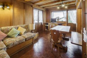 a living room with a couch and a table at Villa Riadezeto - Stayincortina in Cortina dʼAmpezzo