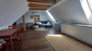 a kitchen and living room with an attic at Apartmány Horka in Kamenná Horka