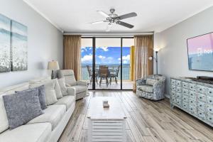 a living room with a couch and a ceiling fan at Summer House Condos in Orange Beach +70 photos