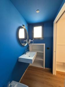 a blue bathroom with a sink and a mirror at Borgomara Bed and Breakfast in Schiavonea +22 photos