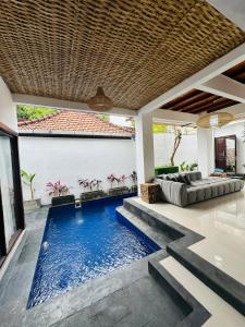 a swimming pool in the middle of a villa at Villa Umah Seminyak in Seminyak