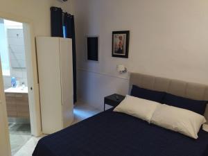 a bedroom with a bed and a bathroom with a sink at 3 Cities Heart 1 in Cospicua