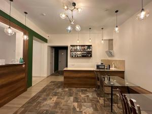 a kitchen with a bar and a dining room at Hotel Tabernei in Tbilisi City