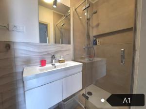 a bathroom with a sink and a shower at San Lorenzo Apartments in Šibenik +24 photos