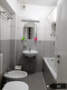 a bathroom with a sink and a toilet and a tub at San Lorenzo Apartments in Šibenik