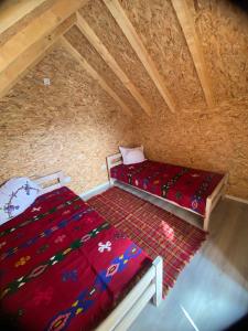a bedroom with a bed and a rug in a attic at Kucice za odmor in Plav