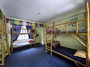 A bed or beds in a room at Hostel 360 Degree, Riverside Stay, Old Manali