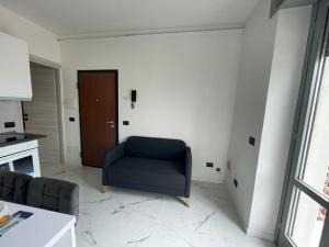 a living room with a blue chair and a door at Luxury Appartament Como, Lago in Como