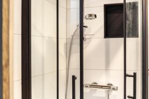 a shower in a bathroom with a glass door at Haus Auner Top 5b in Westendorf +11 photos