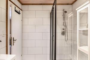 a bathroom with a shower with white tiles at Haus Auner Top 5a in Westendorf