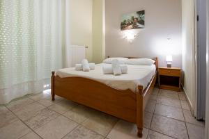 Postel nebo postele na pokoji v ubytování Lucia Hotel Paralia