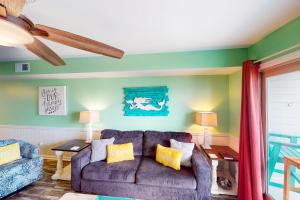 a living room with a couch and a table at Summer House West Condos in Gulf Shores