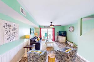 a living room with a couch and two chairs at Summer House West Condos in Gulf Shores